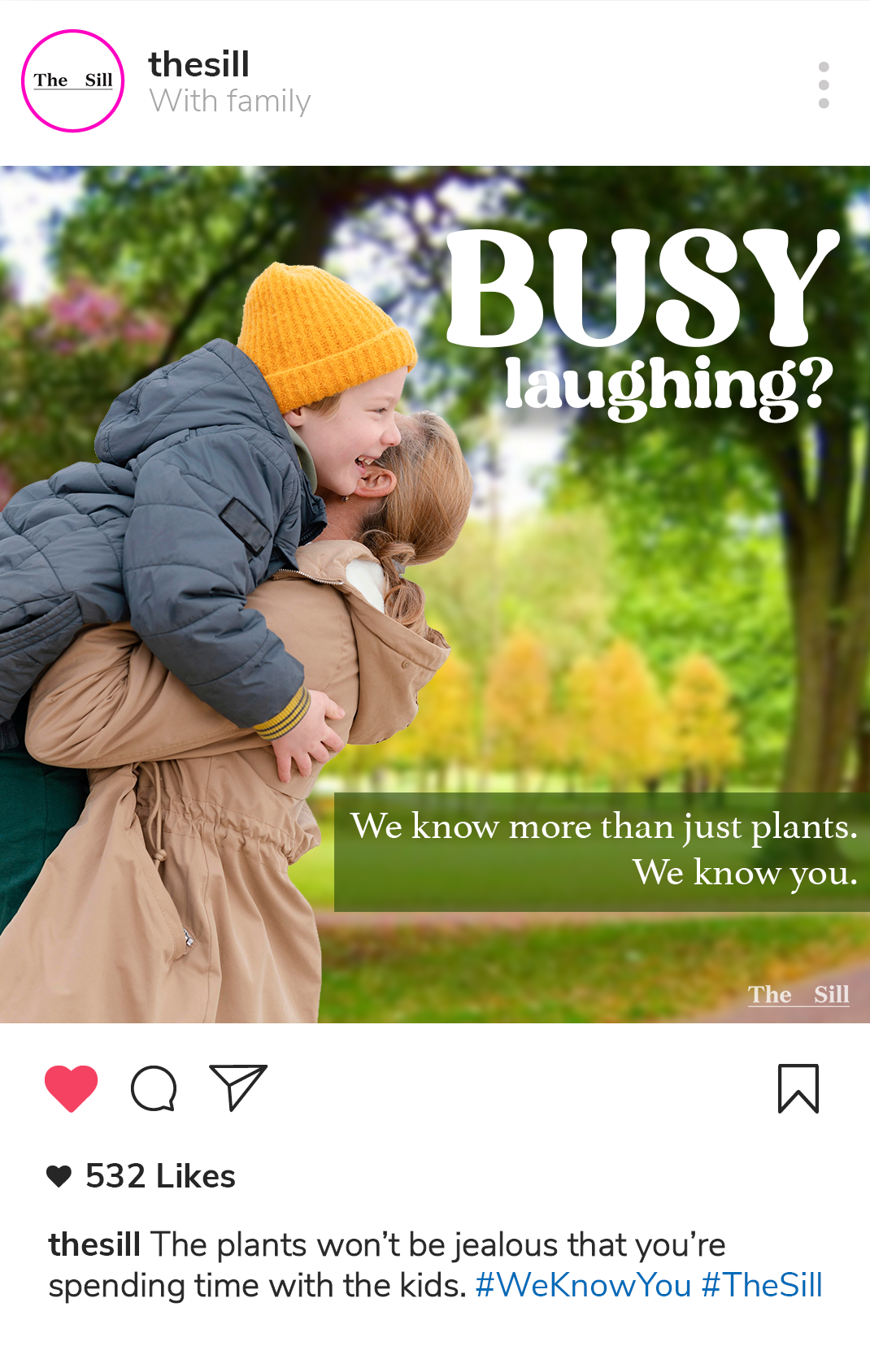 A mockup social post that featues a picture of a woman playing with her kid in a park with text that reads Busy Laughing? Text below reads We know more than just plants, we know you. The caption of the social post reads The plants won’t be jealous that you’re spending time with the kids.