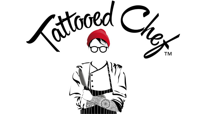 Old logo for Tattoed Chef. Featuring a black and white chef with a red beanie, with crossed tattooed arms. She is holding a knife. Black script font at the top reads Tattooed Chef.